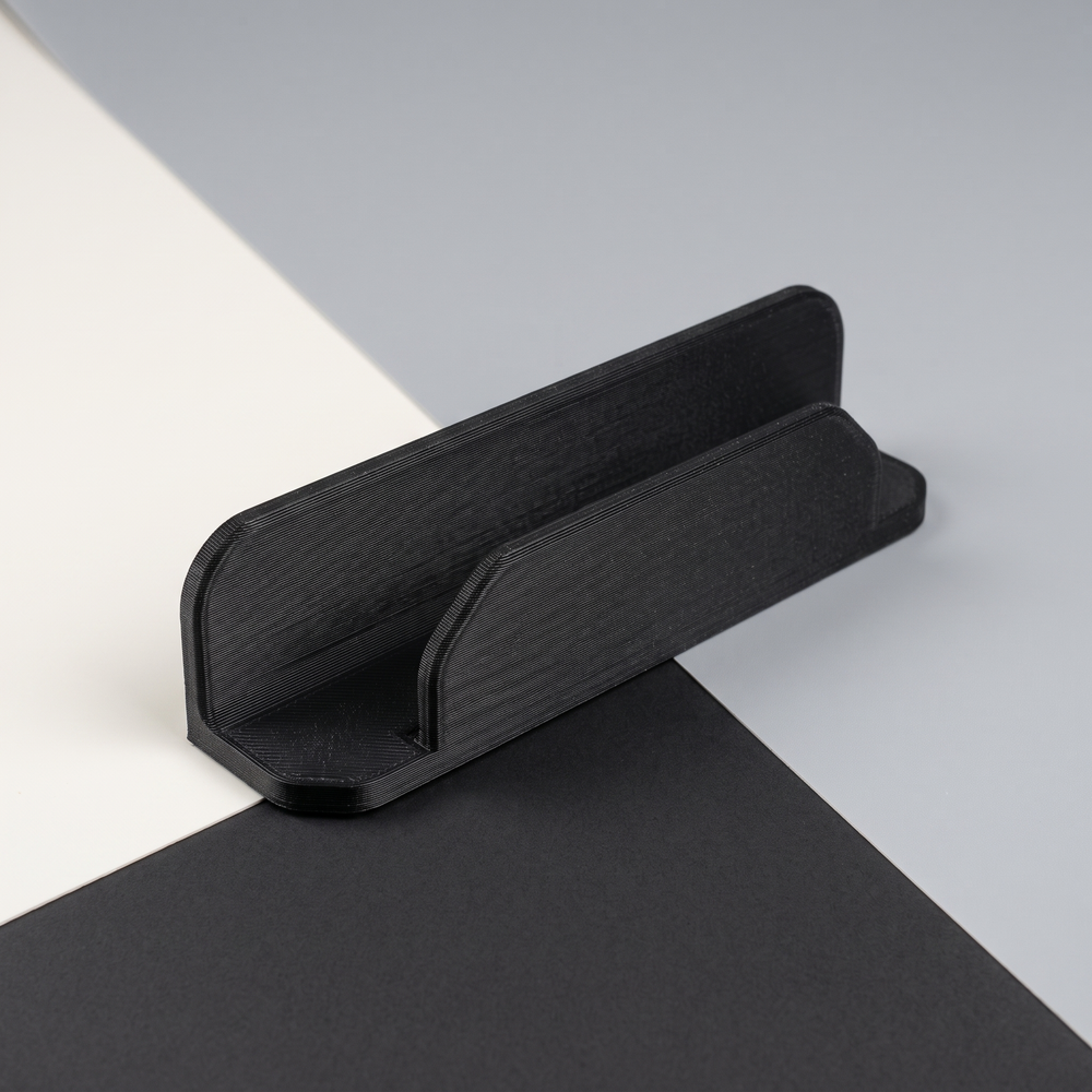 AI-assisted studio illustration of the slim remote-control dock in black PETG. Product only; remote and mounting supplies are not included.