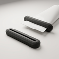 AI-assisted studio illustration of the two-pack black PETG tube squeezers, with one shown on an example unbranded tube. Tube and contents are not included.